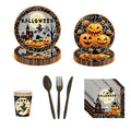 140-piece Halloween party dinnerware set with matching disposable paper plates, cups, napkins, and plastic cutlery.
