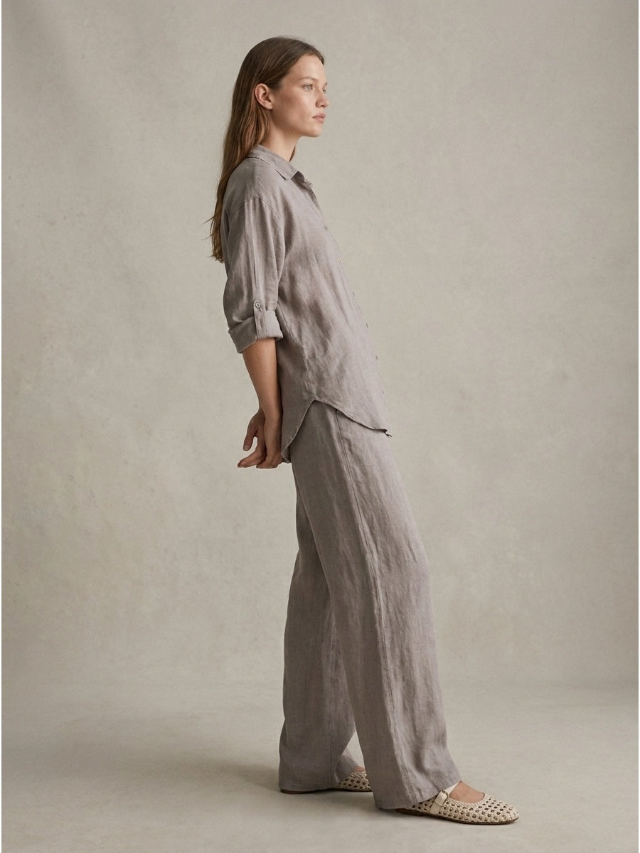 Women's grayish linen trousers from the capsule collection featuring relaxed elegant Italian tailoring