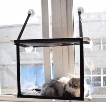Window sill cat hammock in neutral coral velvet mounted to a glass window with suction cups — view 5