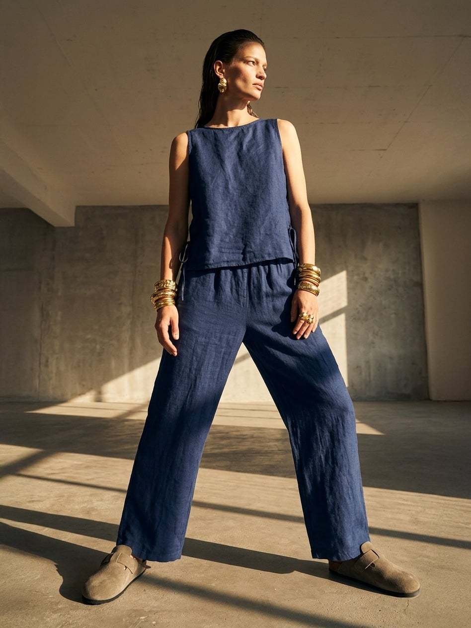 Elegant women's blue pure linen trousers featuring expertly tailored seams and a lightweight, relaxed fit