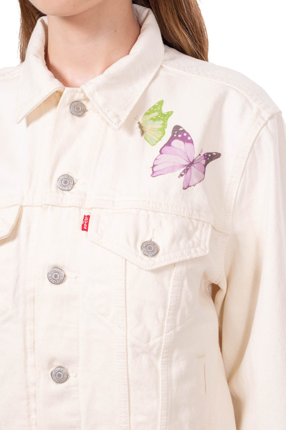 Cream white women's denim jacket featuring a contrasting butterfly graphic print and front button fastening