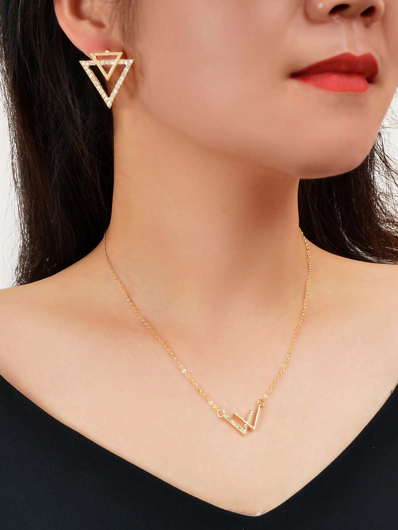 Double V pendant necklace and matching triangle earrings set featuring polished metallic geometric design. — view 2