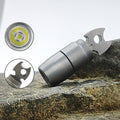 Titanium EDC keychain flashlight with integrated bottle opener attached to metal keyring on plain background
