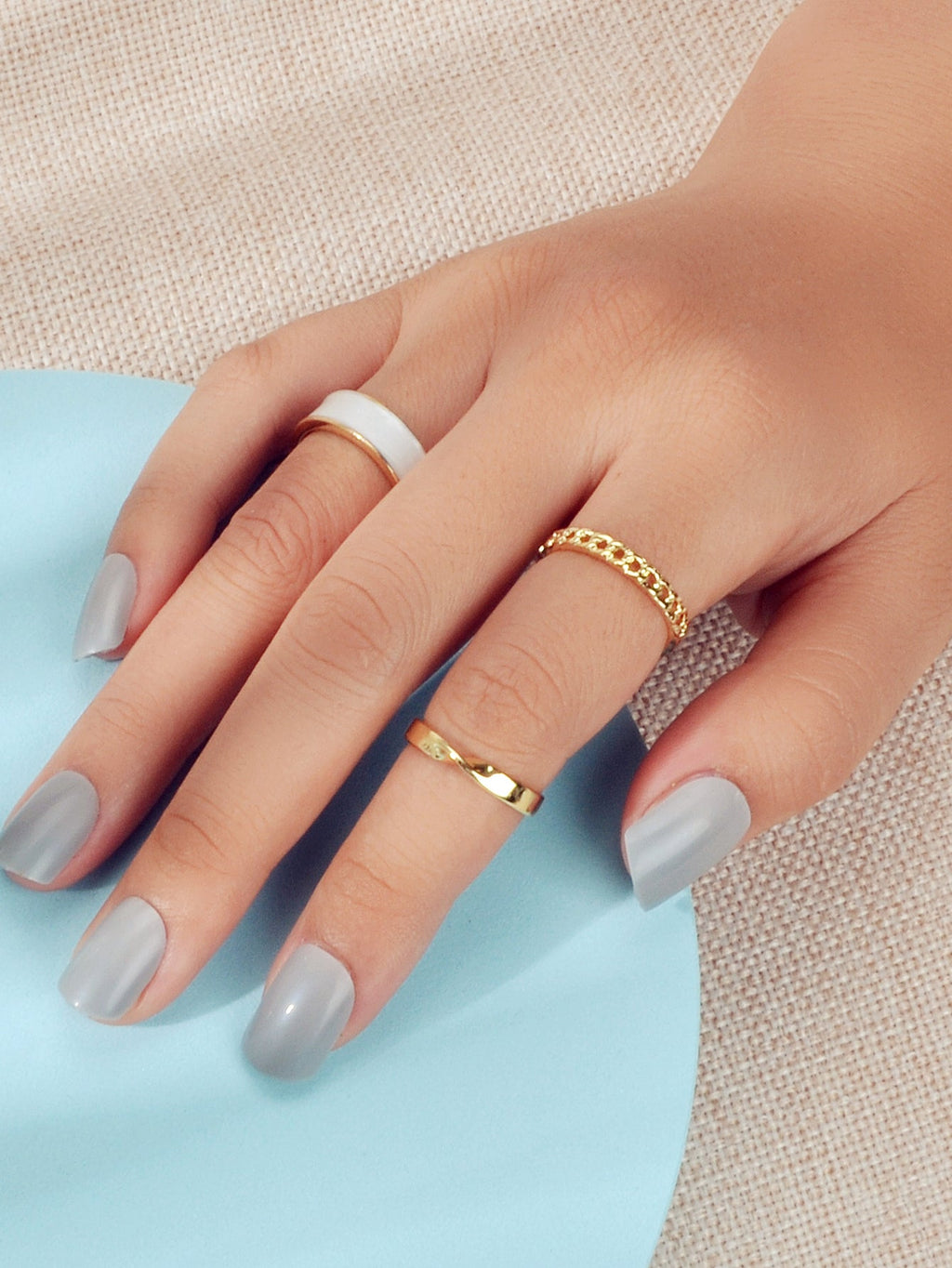 Three piece retro stackable white enamel midi knuckle ring set displayed together