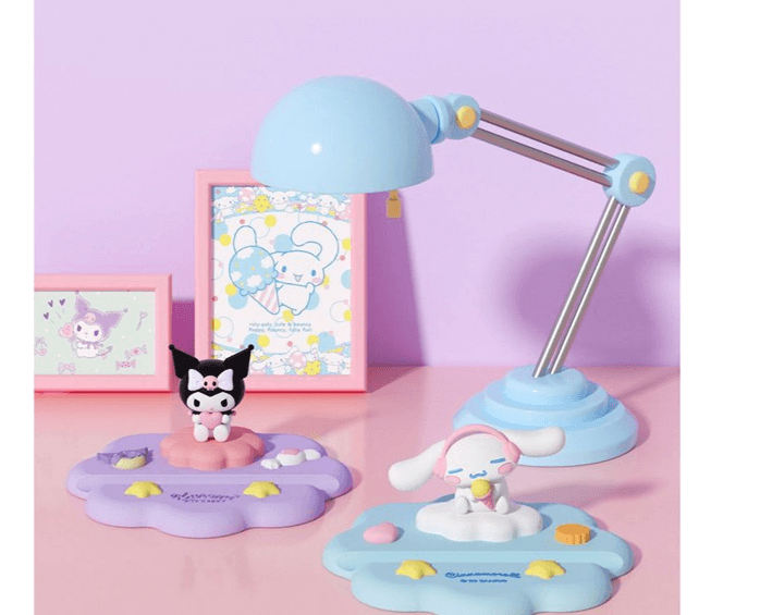 Cute Sanrio character desktop phone stand cradle featuring Kuromi and Cinnamoroll holding a smartphone securely — view 3