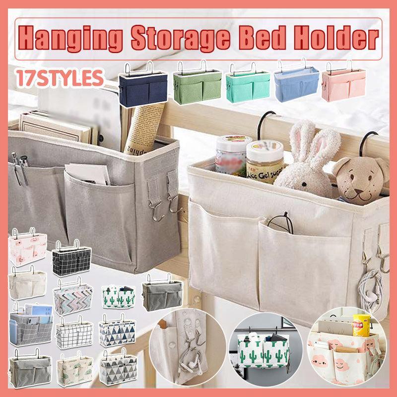 Canvas bedside storage caddy hanging on a bed frame holding books and remote controls