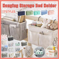 Canvas bedside storage caddy hanging on a bed frame holding books and remote controls
