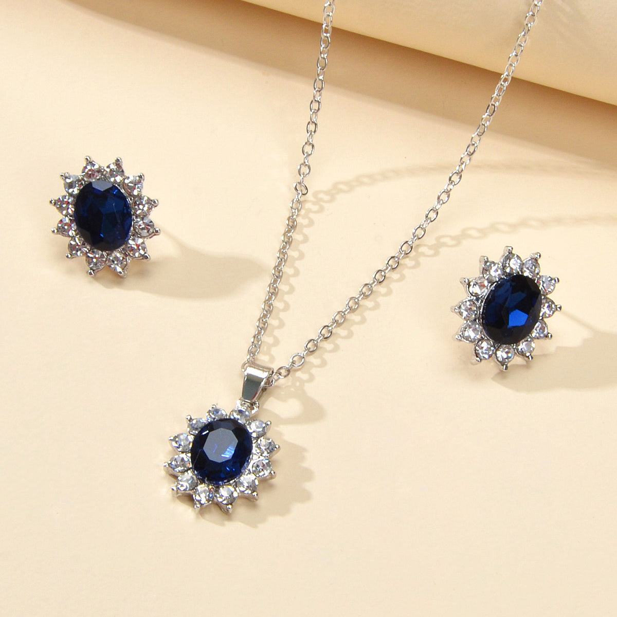 Blue simulated gemstone jewelry set with adjustable charm necklace and matching stud earrings for women