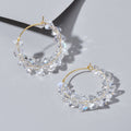 Transparent acrylic bead hoop dangle earrings for women on a clean background.