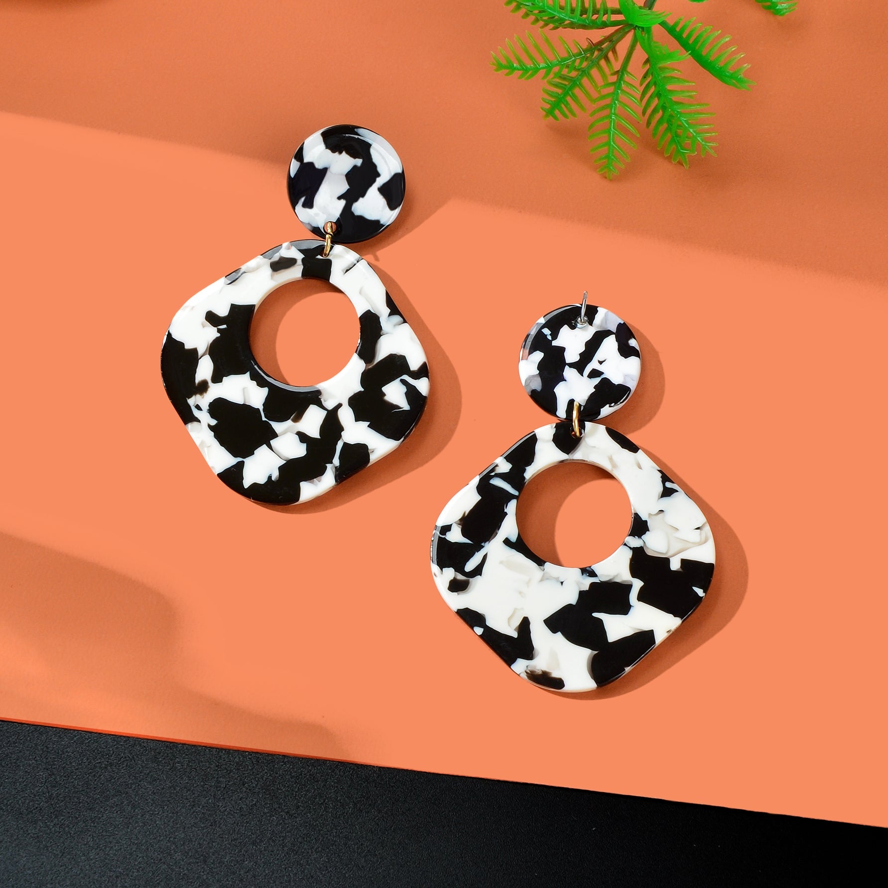 Retro black and white acrylic tortoise shell dangle earrings with round and square geometric design — view 3