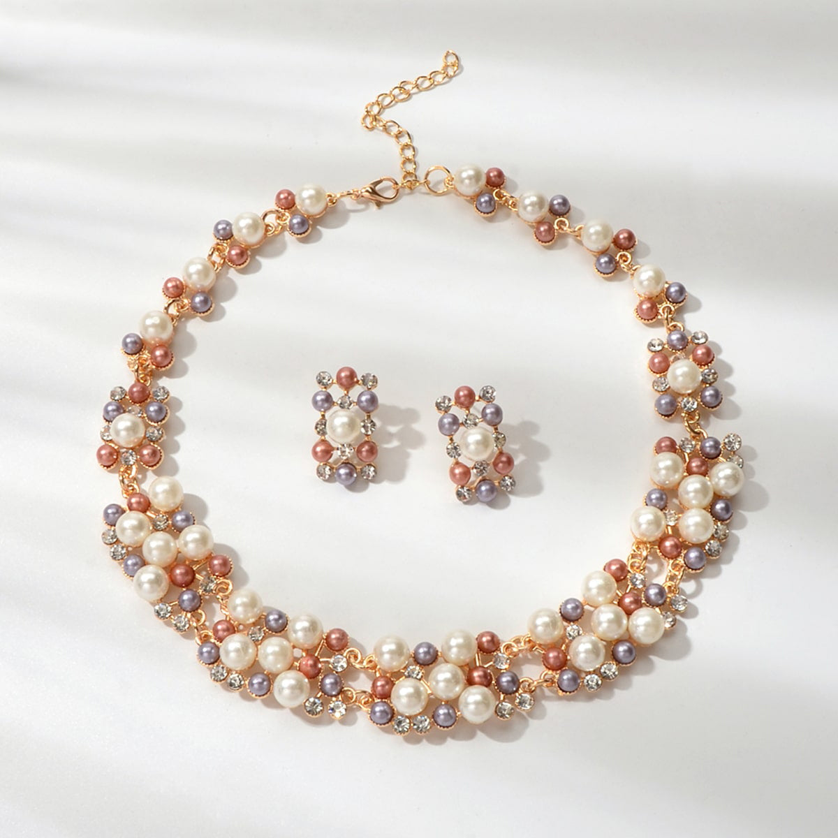 Luxurious rhinestone and pearl collar necklace with matching stud earrings set for formal engagement events.