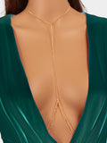 Layered gold and silver tassel body chain worn over a bikini for beach parties