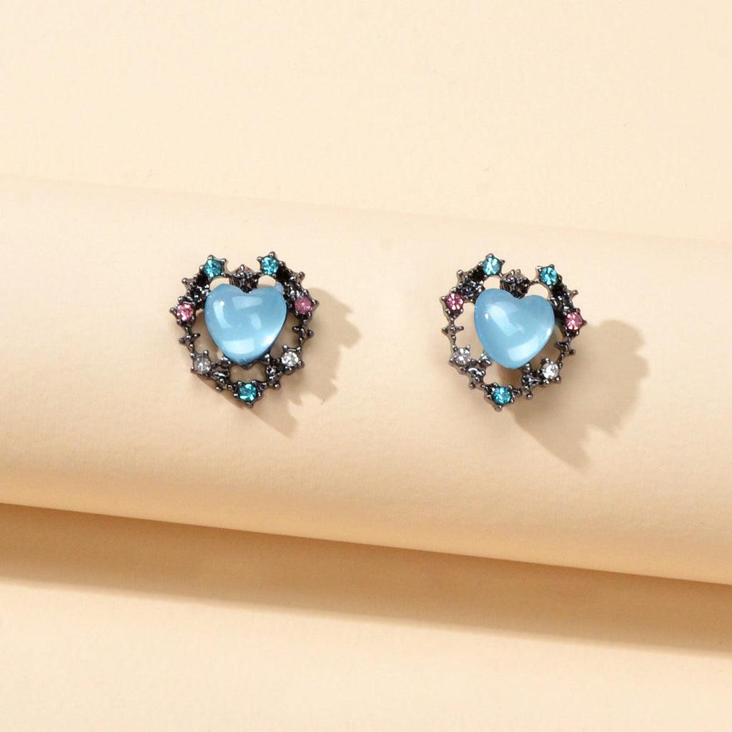 Retro blue opal heart stud earrings with colorful rhinestone halo on a clean background