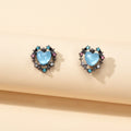 Retro blue opal heart stud earrings with colorful rhinestone halo on a clean background