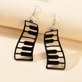 Black and white resin piano keyboard drop statement earrings with dangle design