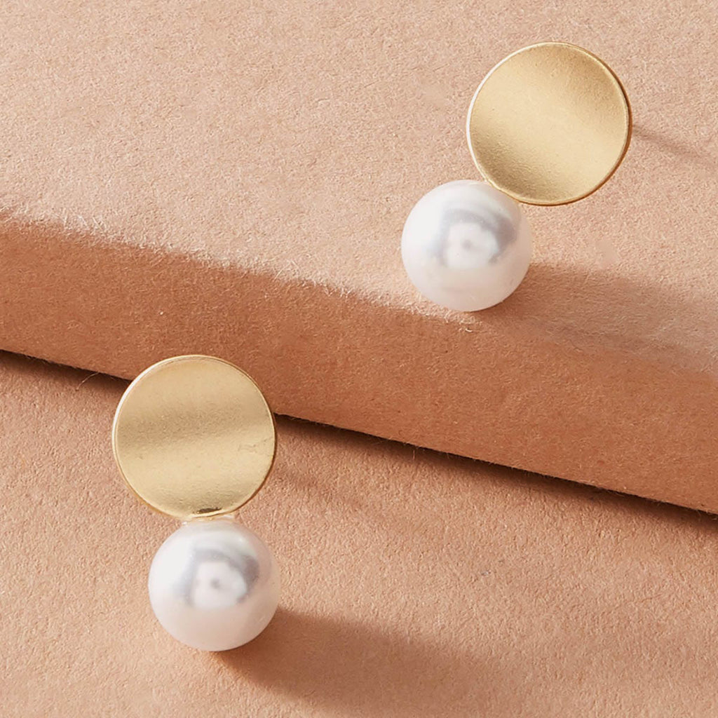 Dainty round gold metal faux pearl stud earrings for daily wear and elegant occasions.