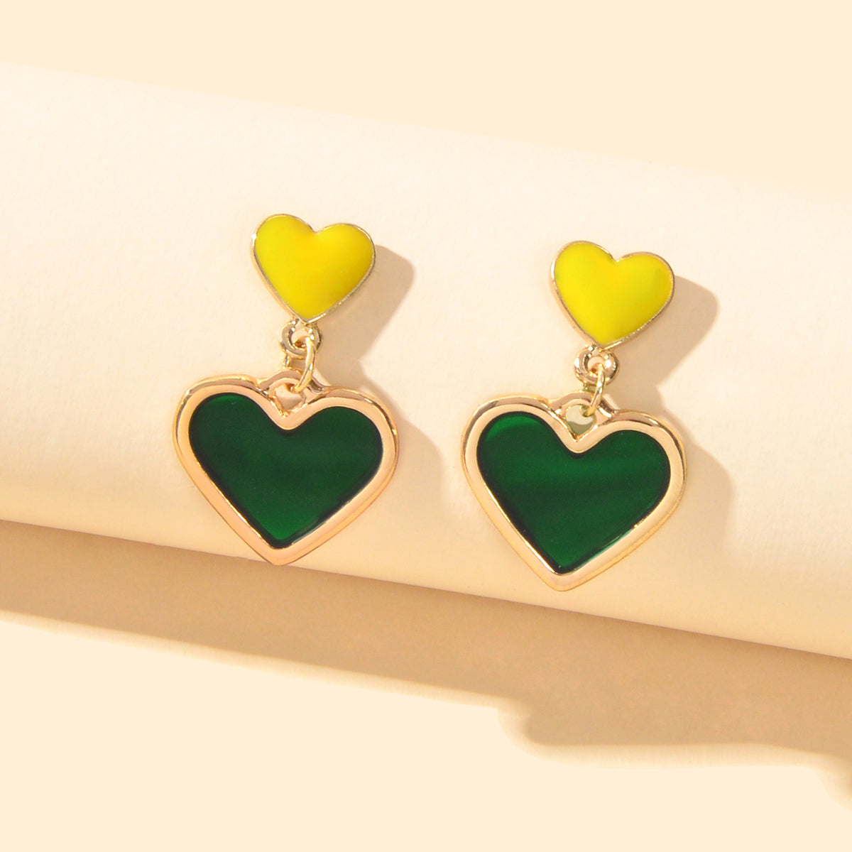 Elegant dangling love heart drop stud earrings for women on a clean background — view 5