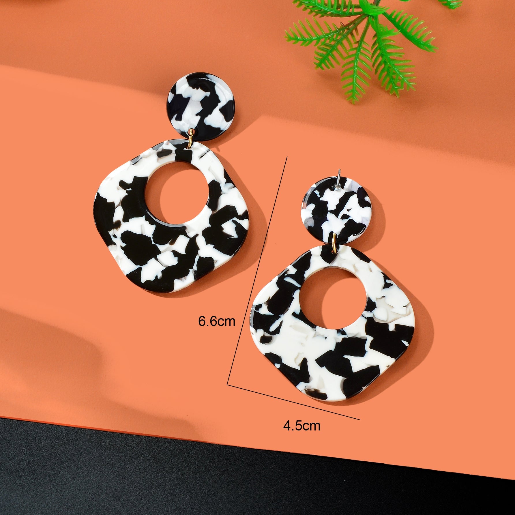 Retro black and white acrylic tortoise shell dangle earrings with round and square geometric design — view 4