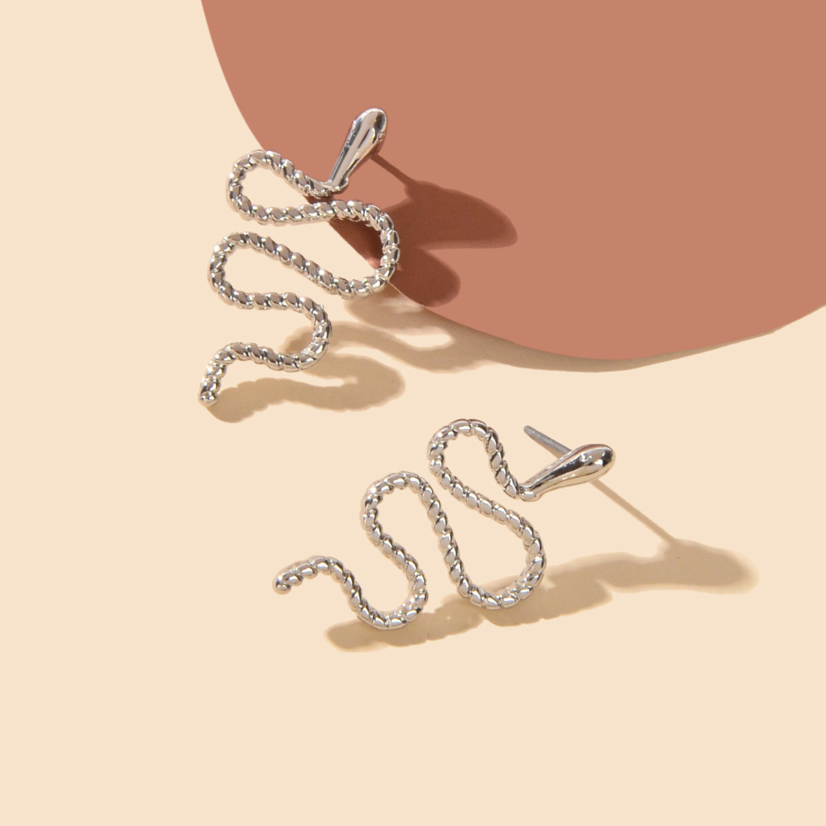 Silver snake stud earrings with intricate gothic serpent design for alternative fashion styles