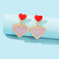 Elegant dangling love heart drop stud earrings for women on a clean background