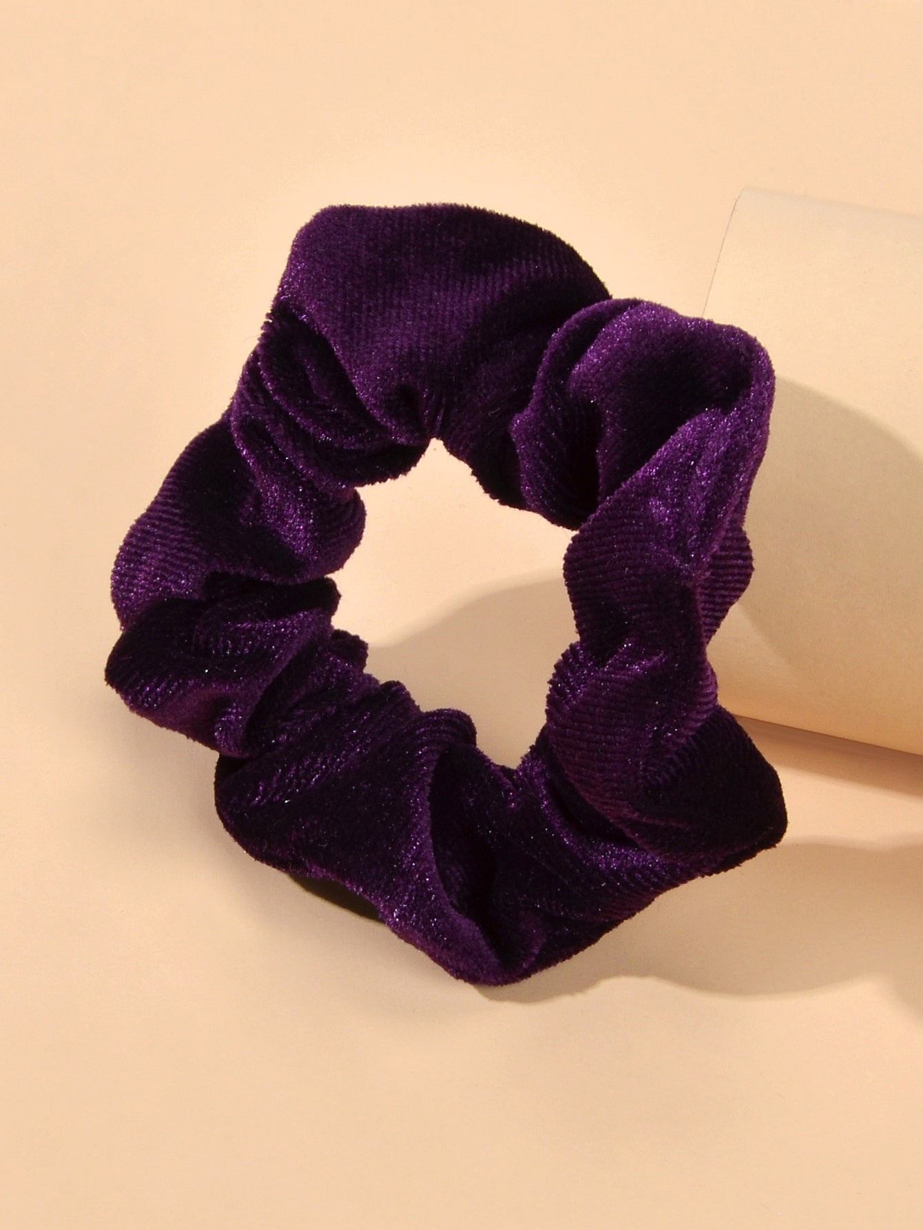 Retro velvet elastic scrunchie hair tie displaying soft fabric texture and flexible circular shape — view 5
