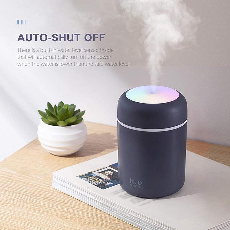 Portable USB car humidifier and essential oil diffuser emitting cool mist on a desk — view 4