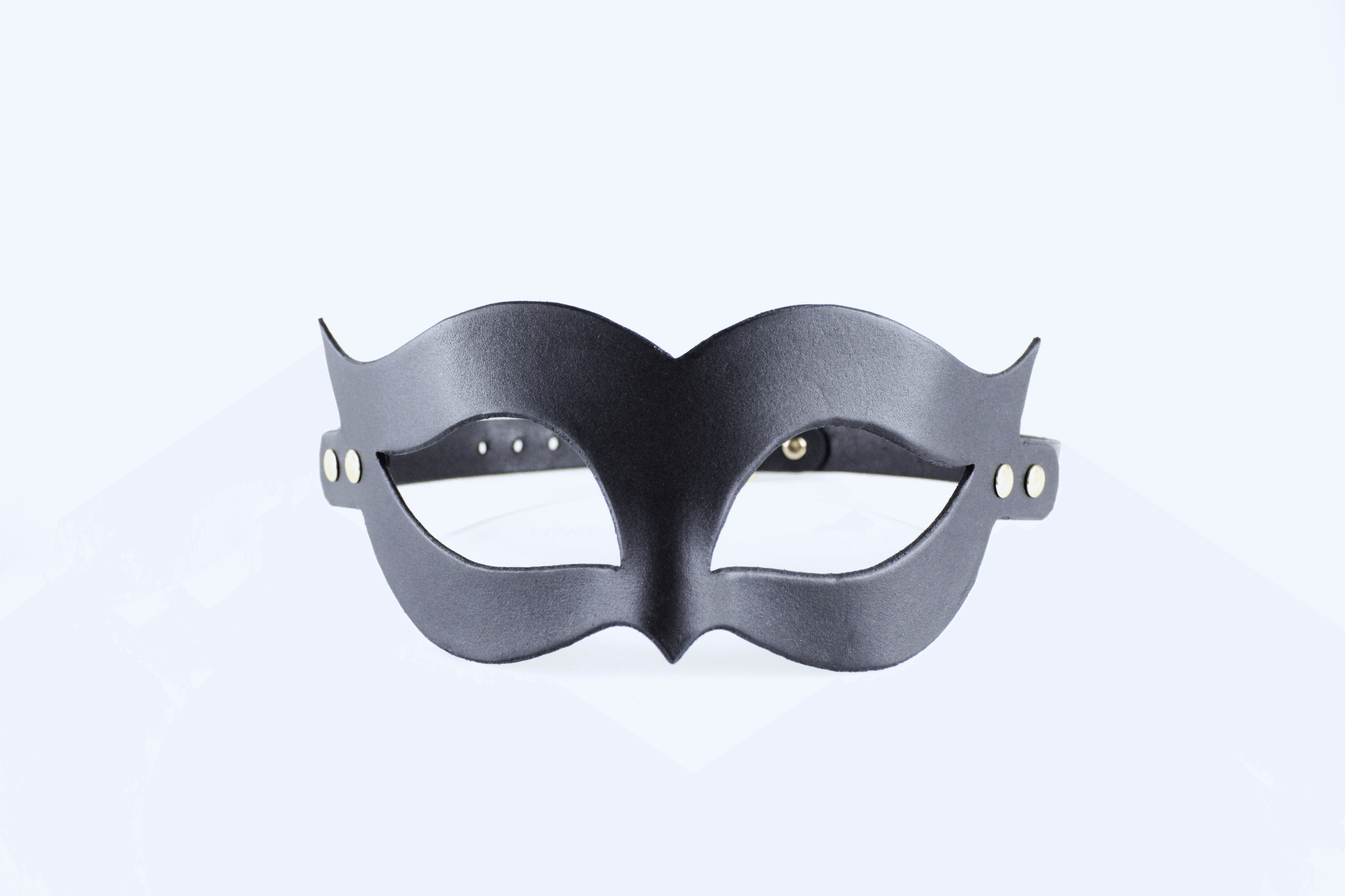 Handmade black leather fetish mask with gold-tone rivets and adjustable buckle strap for a secure fit.