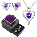 Elegant heart-shaped jewelry set featuring a necklace and earrings with purple cubic zirconia gemstones
