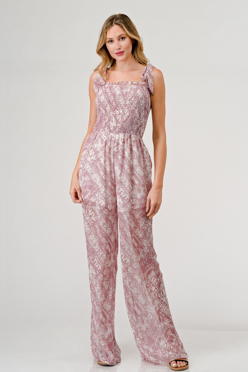 Printed tie shoulder wide leg jumpsuit in lightweight rayon with pockets and smocked details