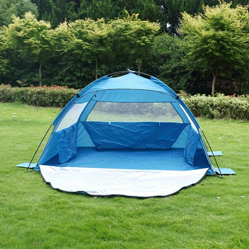 Blue pop-up beach tent sun shelter with extendable footprint and mesh windows on sand. — view 2