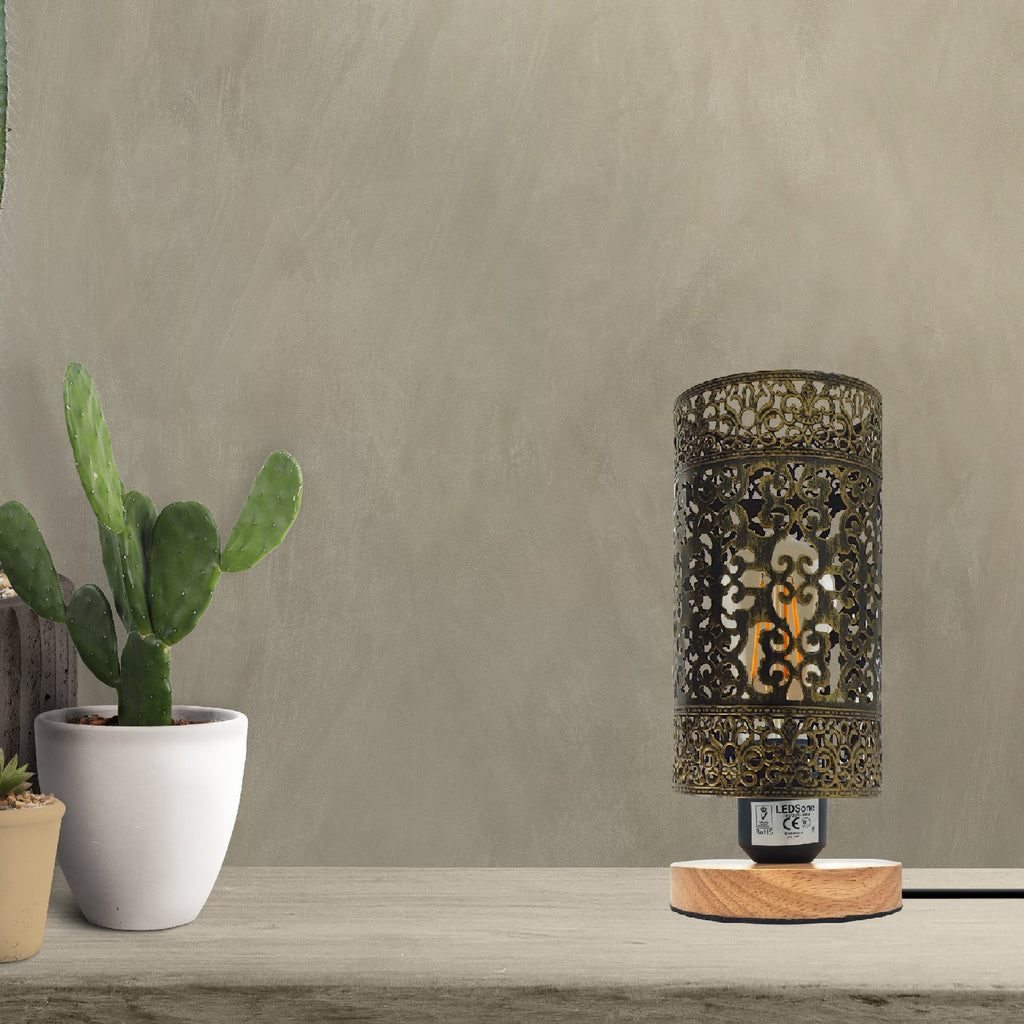 Industrial bedside table lamp with black metal wire cage shade and a natural wood base