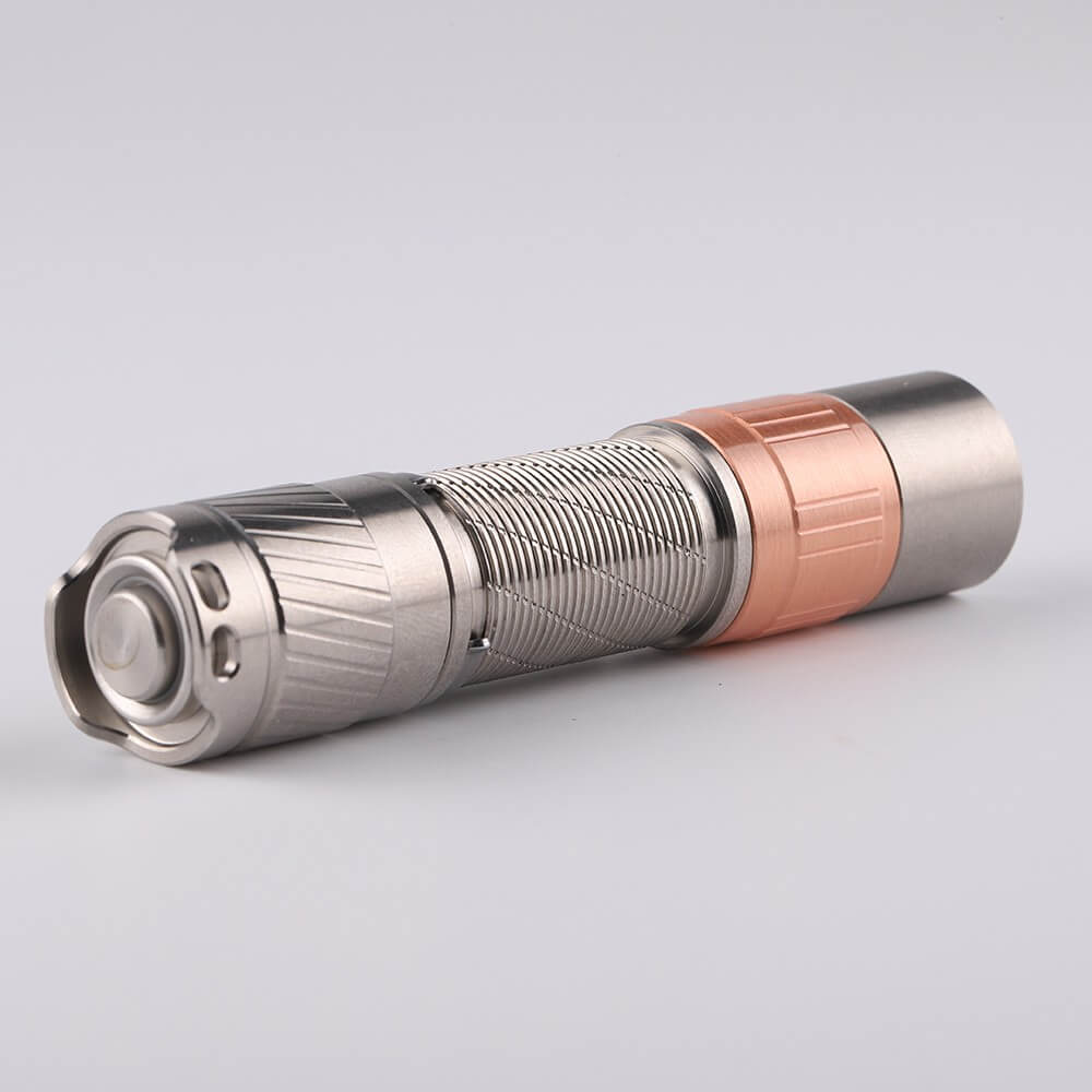 Compact titanium everyday carry flashlight with a metallic finish and tactical tail switch button — view 2