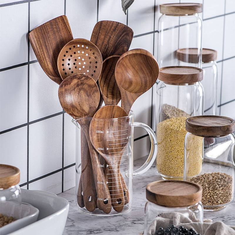 Natural teak wood kitchen utensil set including spoon, ladle, and turner with smooth wood grain