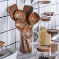 Natural teak wood kitchen utensil set including spoon, ladle, and turner with smooth wood grain
