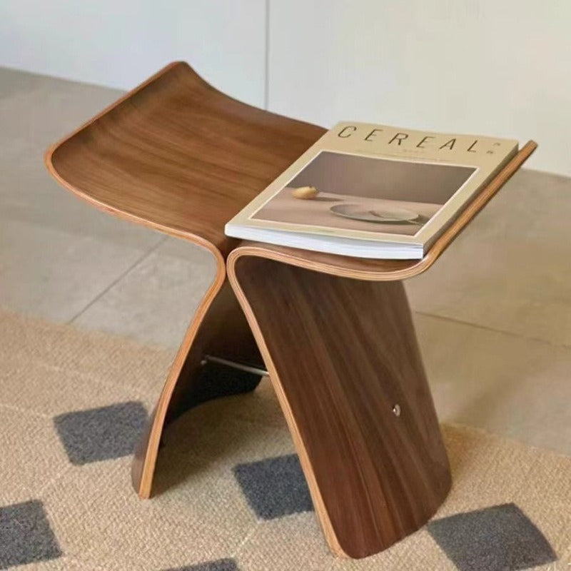 Sculptural wooden accent chair and multifunctional stool with a modern curved silhouette and natural grain finish