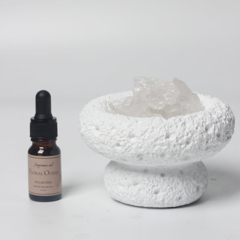 White moon elegant home fragrance diffuser with floral ocean oil set in minimalist setting