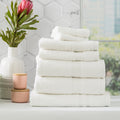 Stack of white Stella bamboo cotton blend luxury bath towels with integrated hanger loops