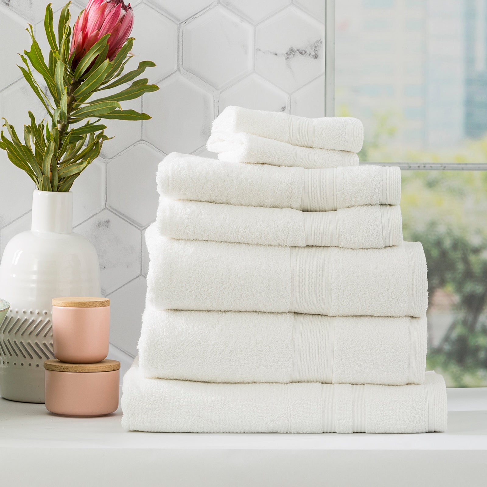 Stack of white Stella bamboo cotton blend luxury bath towels with integrated hanger loops