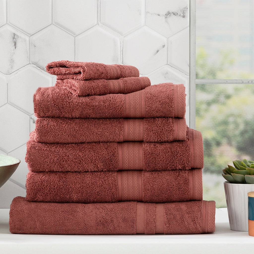 Stella bamboo cotton blend towel set in brick red neatly folded on a bathroom counter