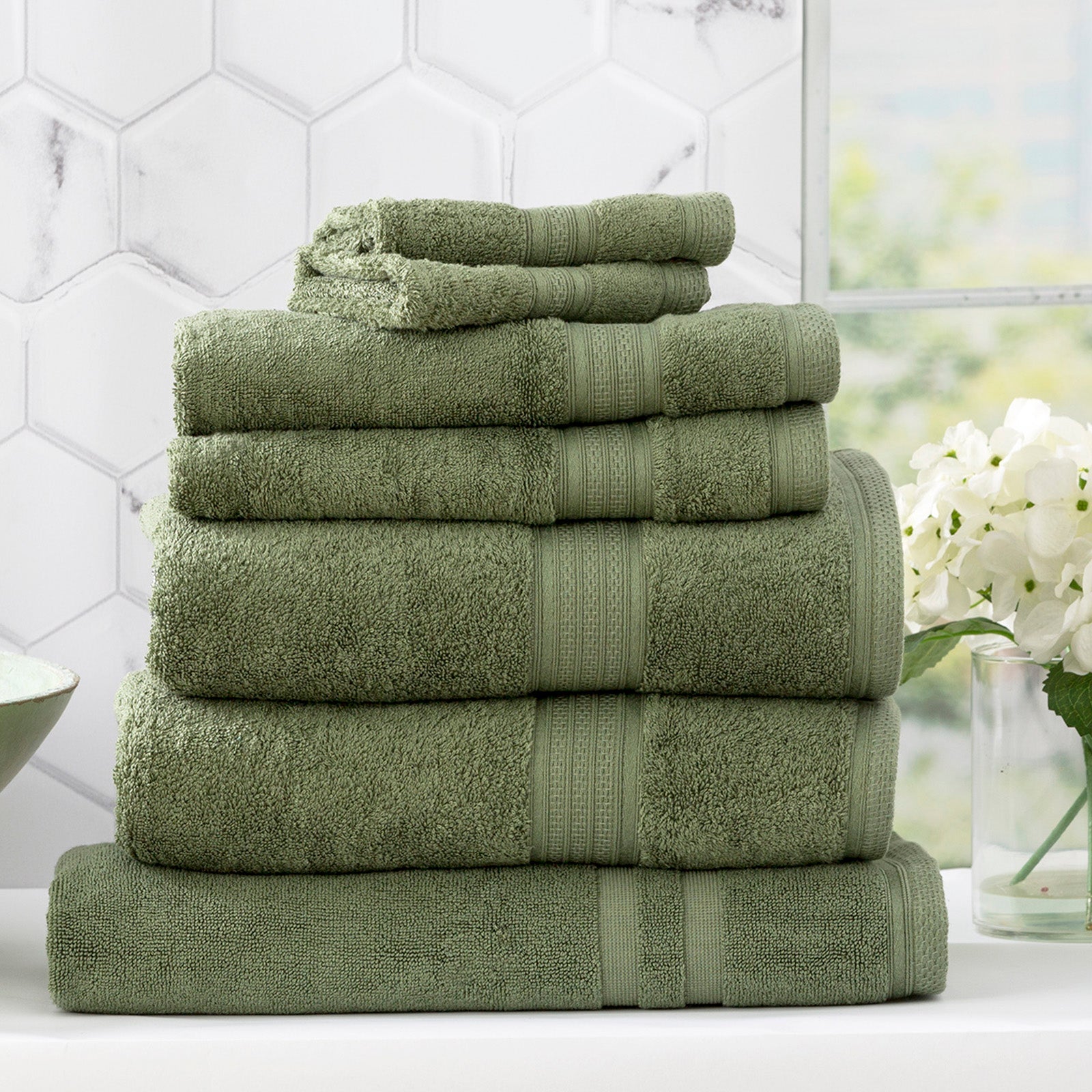 Jade green bamboo cotton bath towel set neatly stacked to showcase plush, absorbent texture
