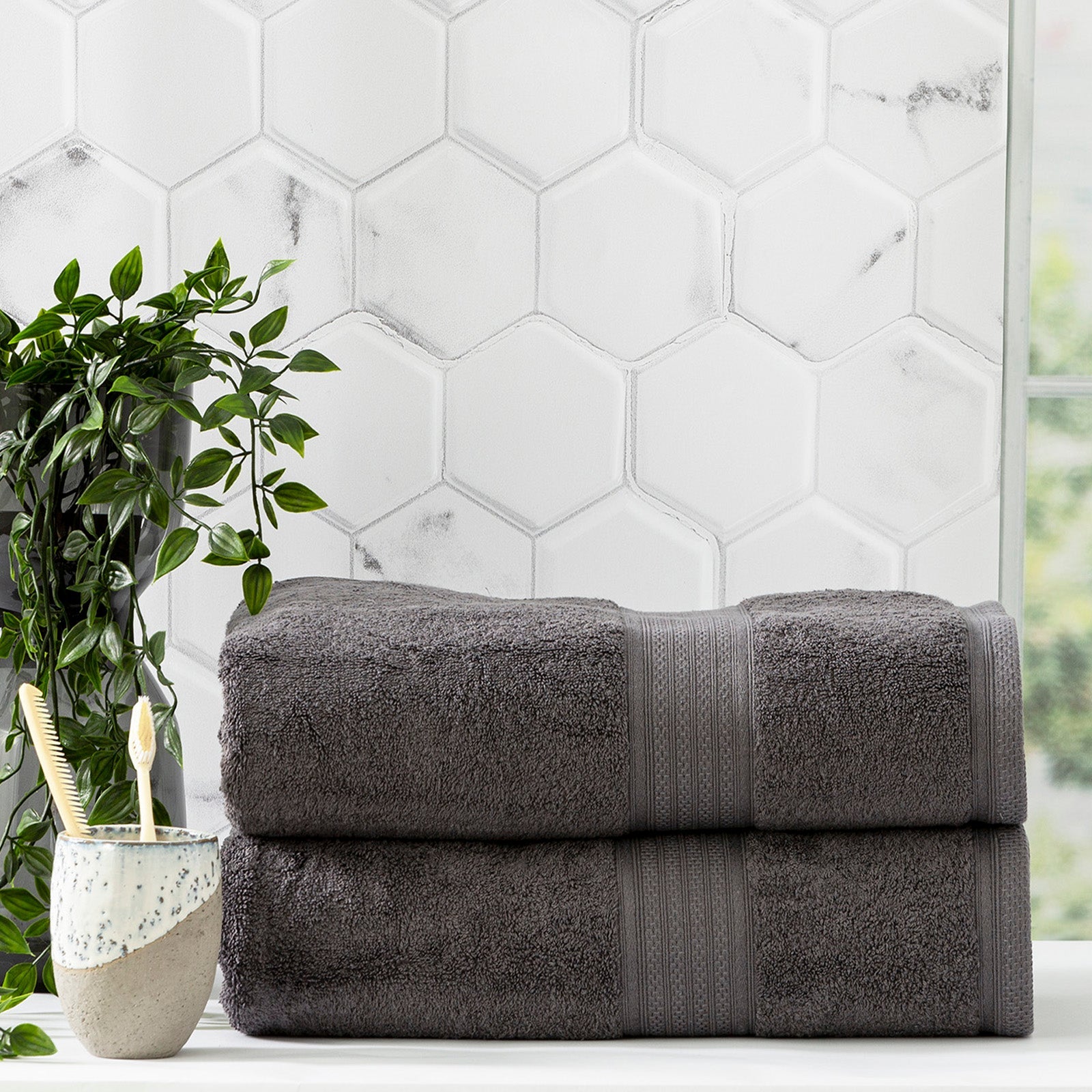 Charcoal grey bamboo cotton bath towel set neatly folded in a luxurious bathroom setting — view 3