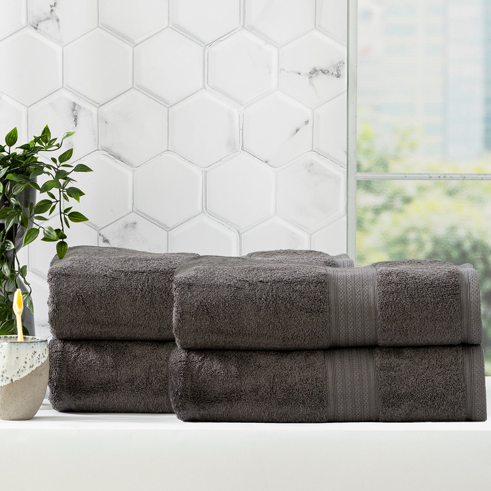 Charcoal grey bamboo cotton bath towel set neatly folded in a luxurious bathroom setting — view 4
