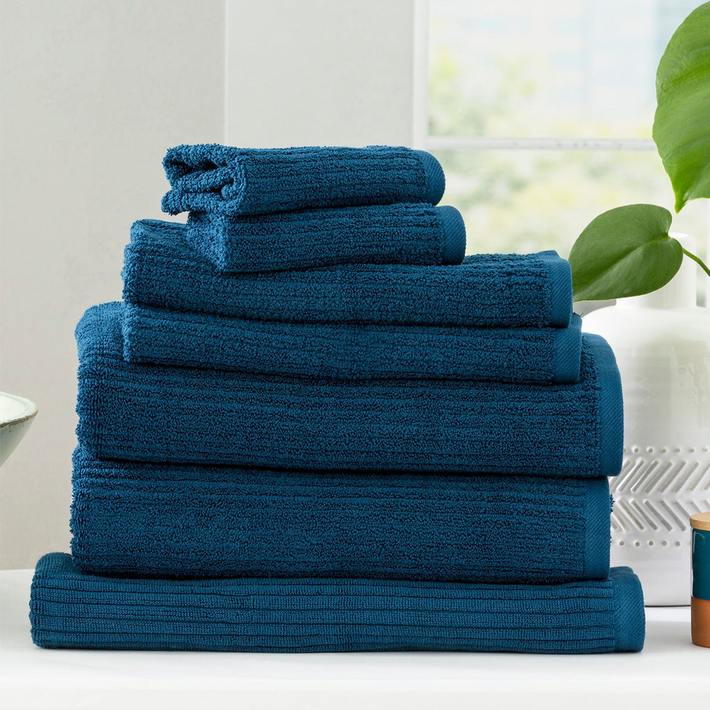 Cobblestone ribbed bath towel set in ink blue folded plush cotton luxury bathroom linens