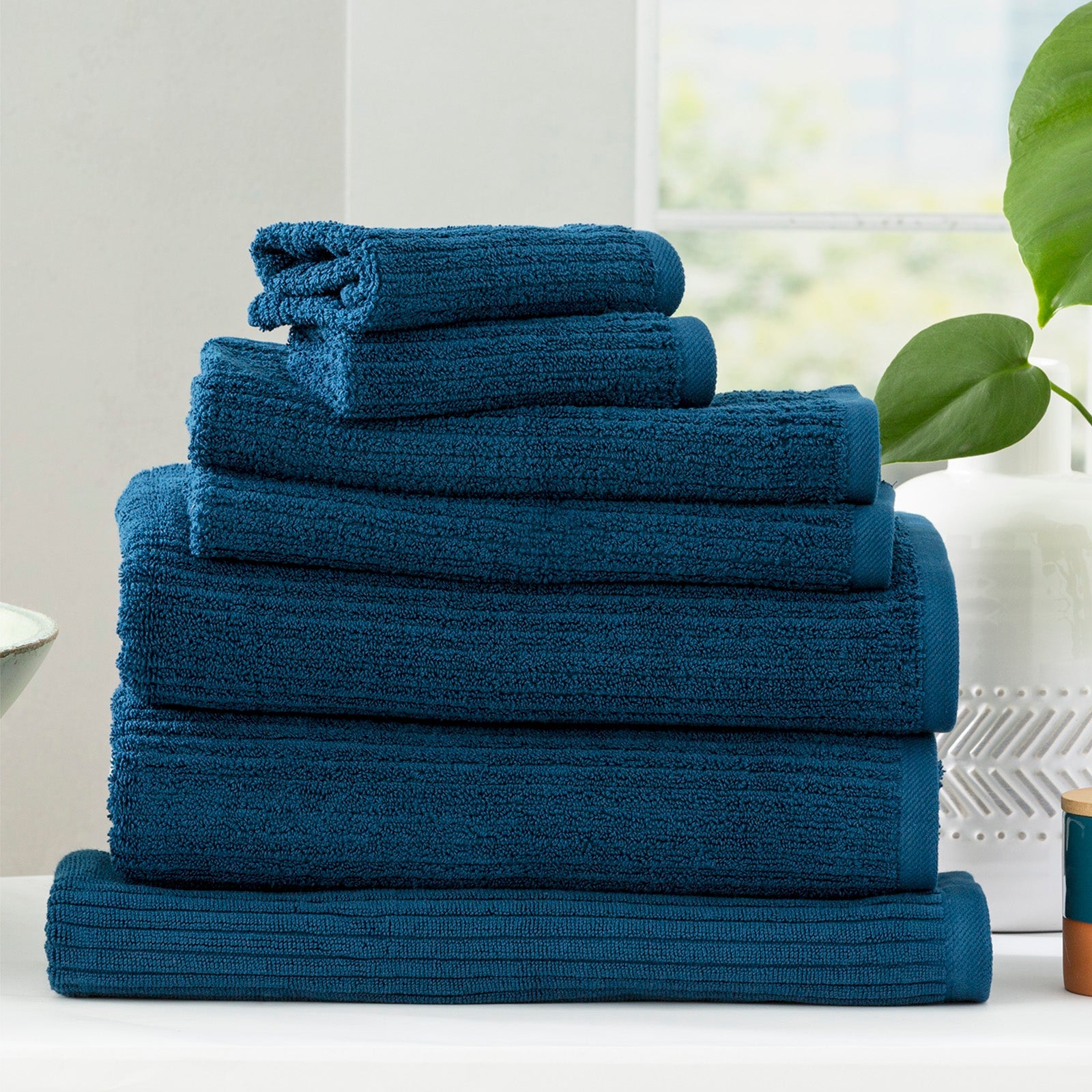 Cobblestone ribbed bath towel set in ink blue folded plush cotton luxury bathroom linens