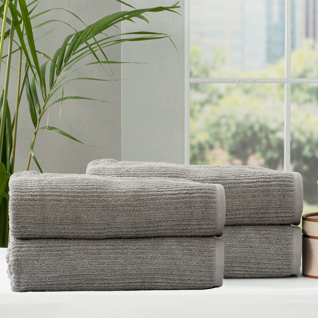 Folded stack of plush cobblestone ribbed platinum bath towels made from thick cotton yarn — view 4