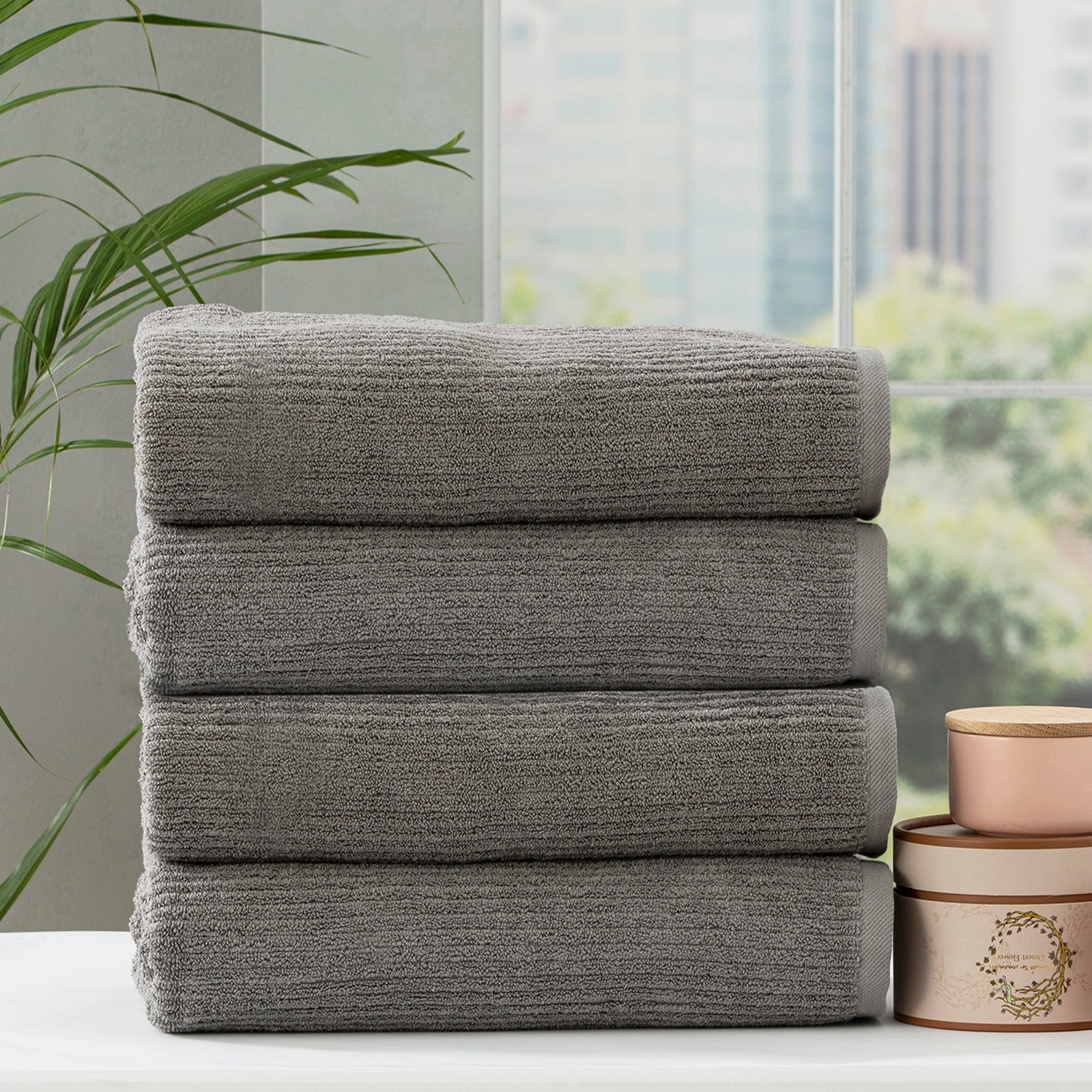 Folded stack of plush cobblestone ribbed platinum bath towels made from thick cotton yarn — view 5