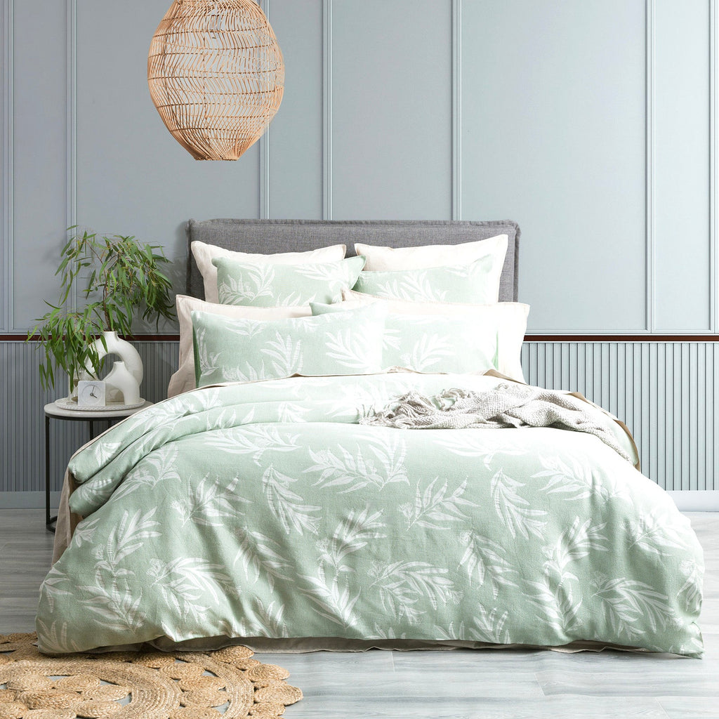 Juniper green native cotton jacquard quilt cover set with matching pillowcases and delicate botanical pattern.