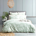 Juniper green native cotton jacquard quilt cover set with matching pillowcases and delicate botanical pattern.