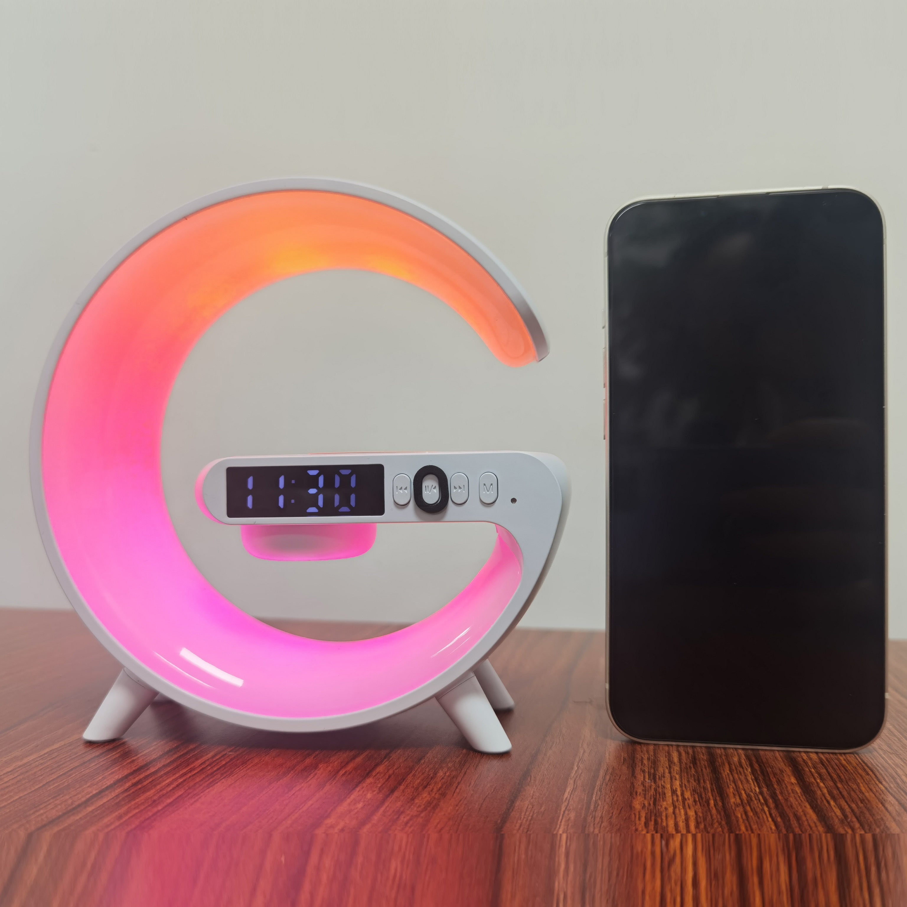 White wireless Bluetooth speaker with RGB rhythm light and fast charging base on a tabletop — view 3