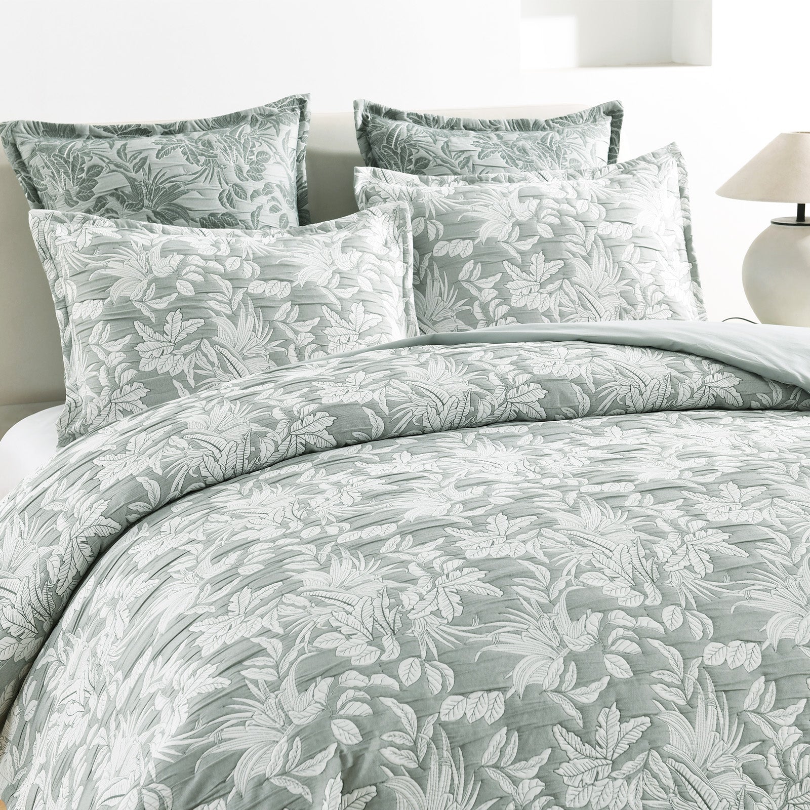 Green Indiana jacquard quilt cover set on a bed showing textured cotton matelasse weave — view 2